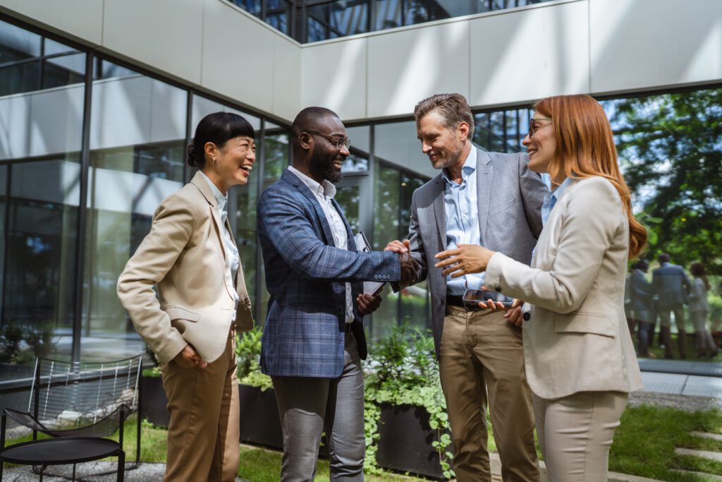 Diverse business leaders shaking hands during an international franchise partnership meeting