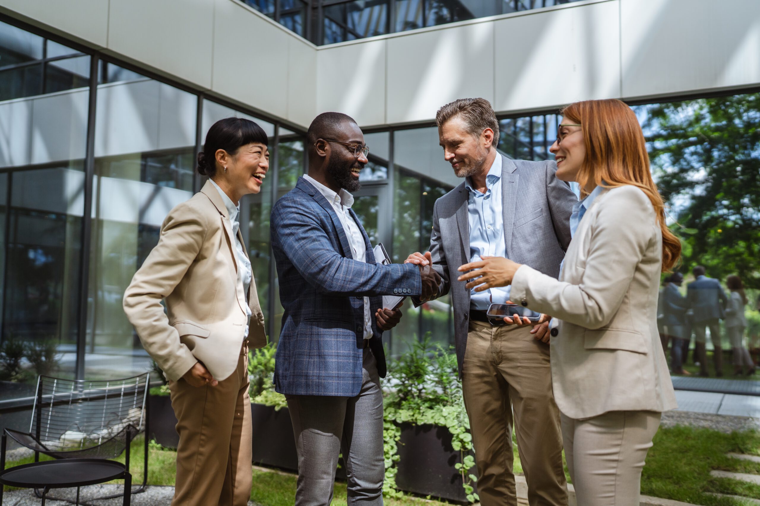 Diverse business leaders shaking hands during an international franchise partnership meeting